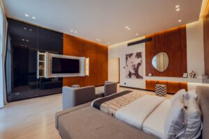 Luxury villa bedroom with modern furnishings and TV