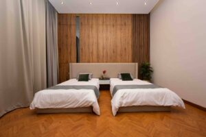 Twin bedroom with wood paneling in a luxury villa