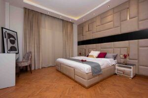 Bedroom with upholstered headboard in a villa with private pool