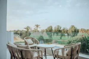 Outdoor balcony seating area with golf course view at Villa Onyx, a luxury 4-bedroom villa with private pool, sauna and gym by Auja Residence.