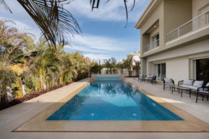 Private villa swimming pool surrounded by gardens